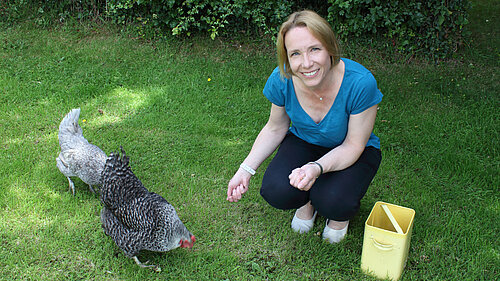 Helen feeding her chickens