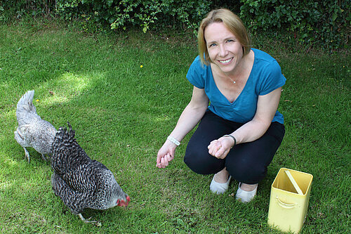 Helen feeding her chickens