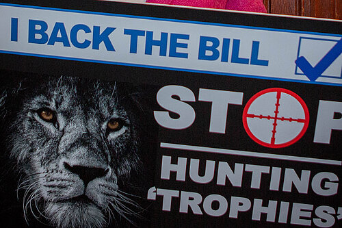 Helen holds a stop trophy hunting poster