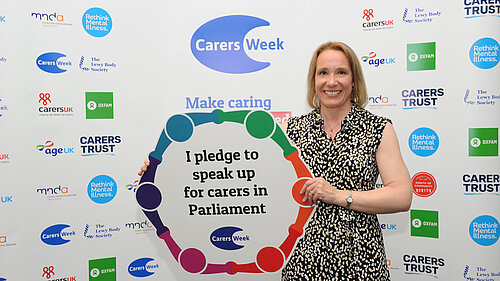 Helen Morgan with a Carers' pledge poster