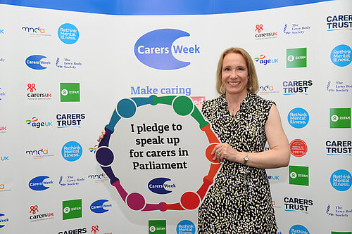 Helen Morgan with a Carers' pledge poster