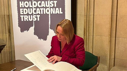 Helen signs the Holocaust book of commitment