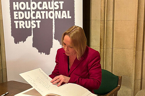 Helen signs the Holocaust book of commitment