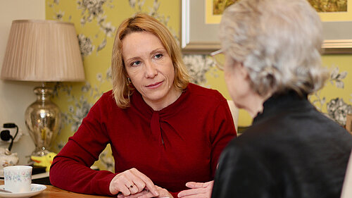 Helen listening to a retired resident