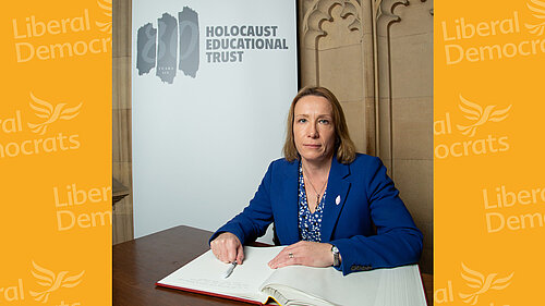 Helen signing the Book of Commitment to mark the 80th anniversary of the Holocaust