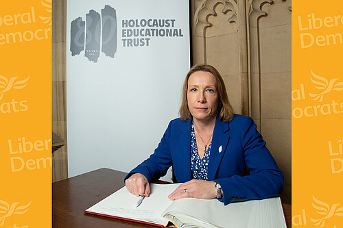 Helen signing the Book of Commitment to mark the 80th anniversary of the Holocaust