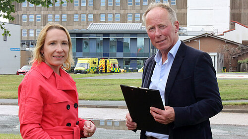 Helen Morgan outside A&E with ambulances