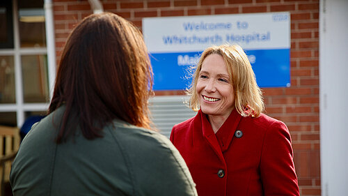 Helen speaking to a resident outside a Shropshire hospital