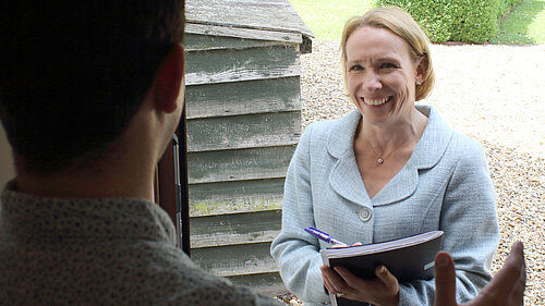 Helen speaking to a resident on their doorstep