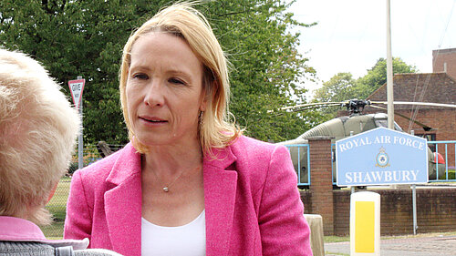 Helen Morgan outside RAF Shawbury with Helicopter