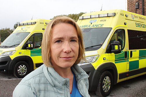 Helen Morgan with a local ambulance
