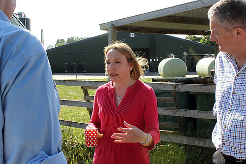 Helen talking to farmers at a local farm