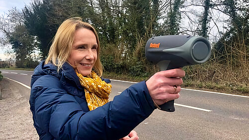 Helen uses a speed-gun to check speeding vehicles