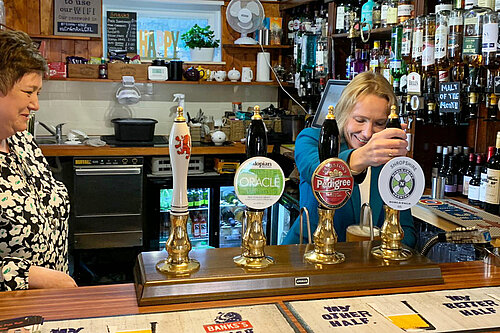 Helen Morgan pulling pints at the Red Lion pub