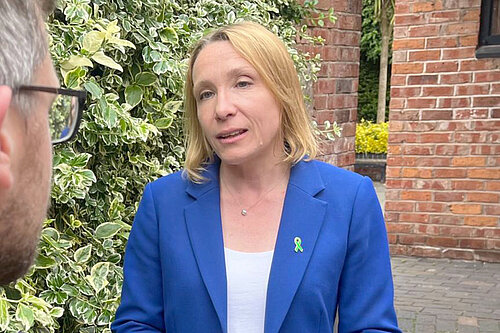 Helen Morgan wearing a green ribbon pin badge